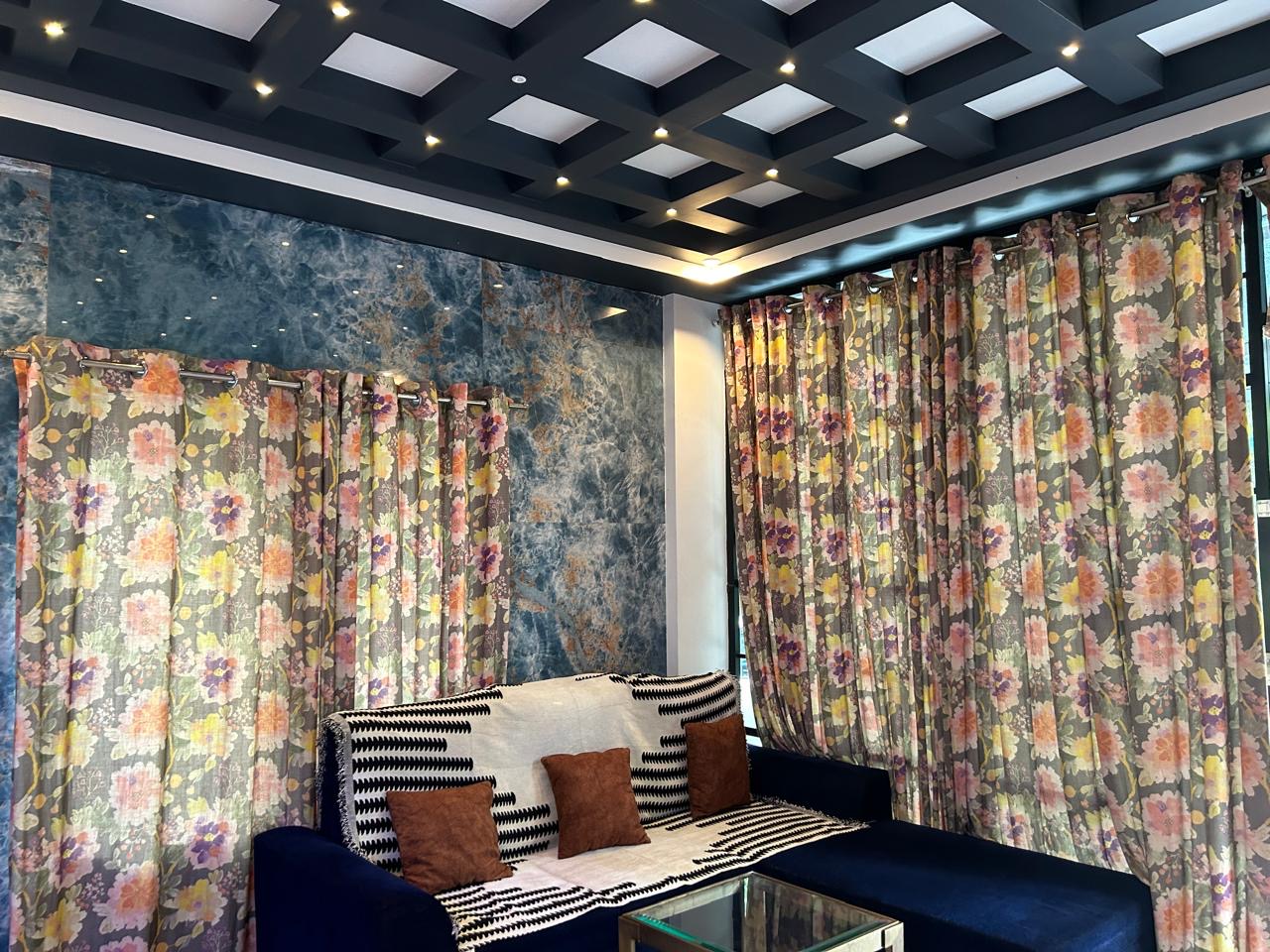 Living lounge with sofa and floral curtains